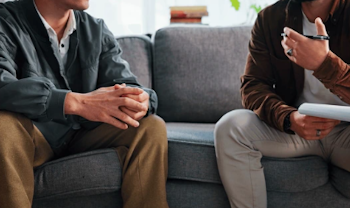 Man talking with a therapist, representing men’s therapy in Seattle
