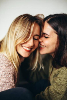 Two women sharing a close moment, representing LGBTQ+ premarital counseling in Seattle
