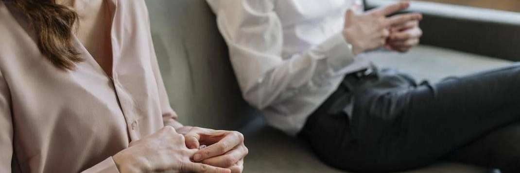 Couple sitting on couch in Seattle couples counseling.