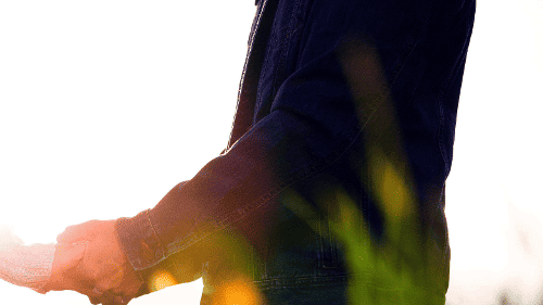 Person holding their partner's hands