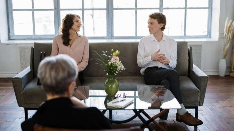 Couple sitting on couch in Seattle relationship therapy.