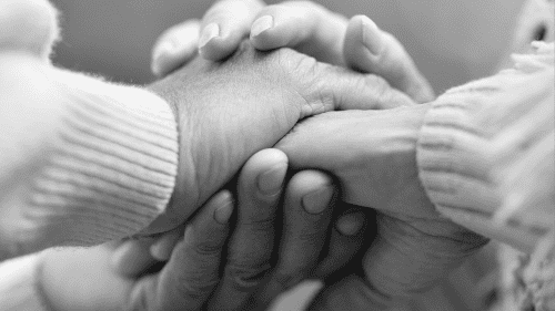 Older couple holding hands