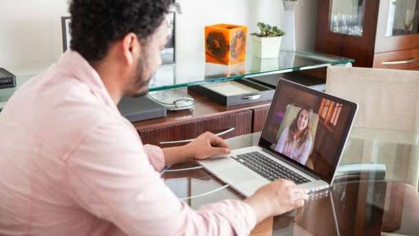 Man sitting on couch during telehealth therapy in Seattle