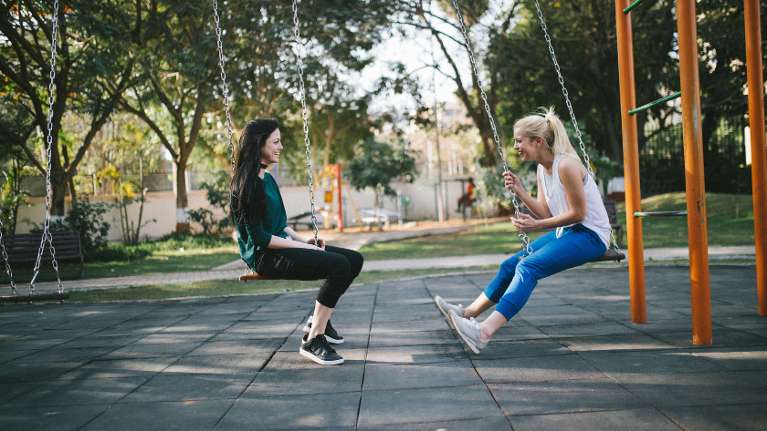 Women in Seattle on swing making connection.