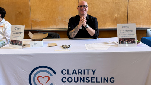 Clarity Counseling Seattle booth at local therapy job fair connecting with future therapists in Seat
