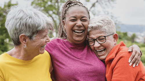 Three older women laughing