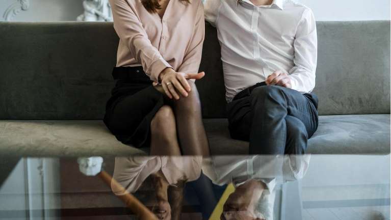 Couple sitting on couch during sex therapy for couples in Seattle