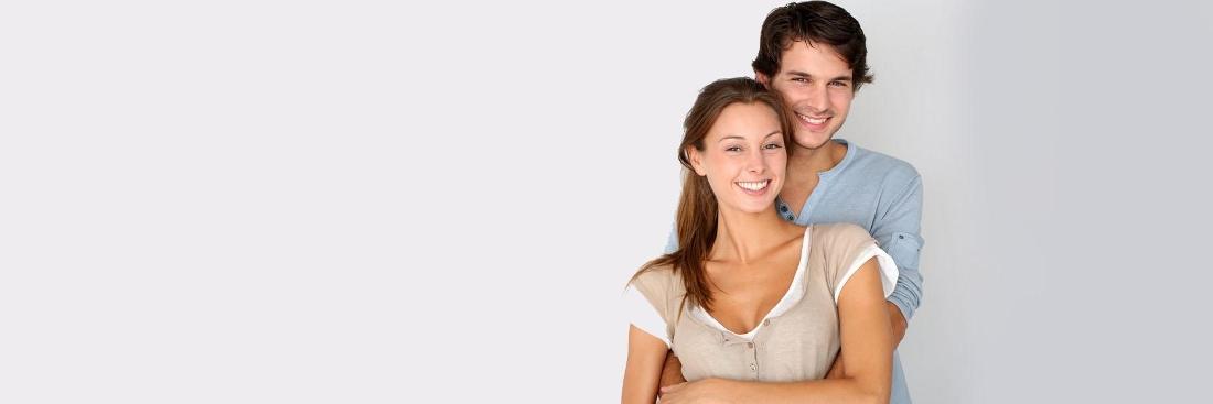 Young couple smiling at couples counselor in Seattle, WA