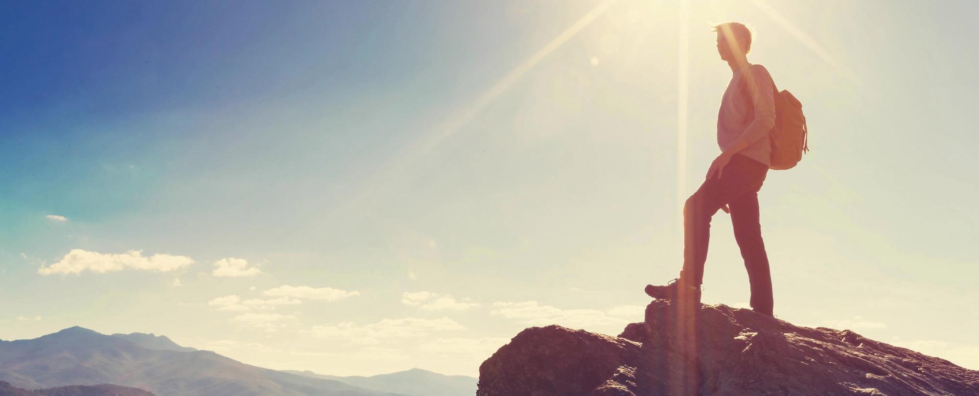 Man climbing mountain after therapy appointment in Seattle