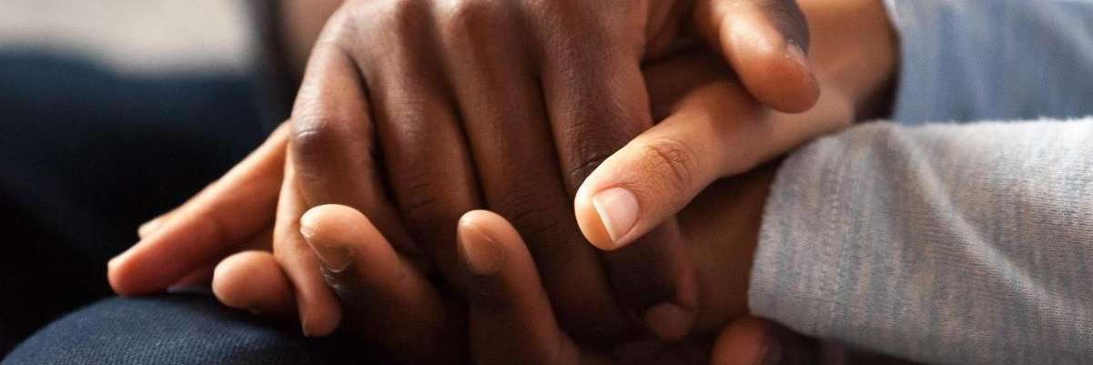 Couple holding hands during relationship therapy in Seattle, WA